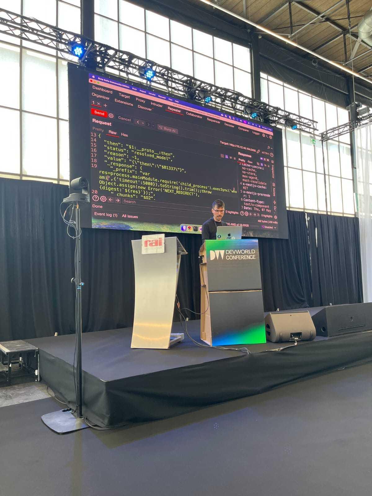 Live exploit demo with Burp Suite on the big screen at DevWorld Conference 2026